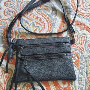 Gray purse with lots of zippers
